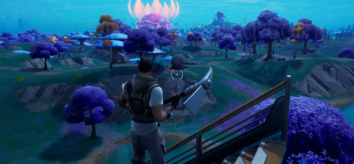 In-game screenshot of Fortnite showing character standing with harvest tool.